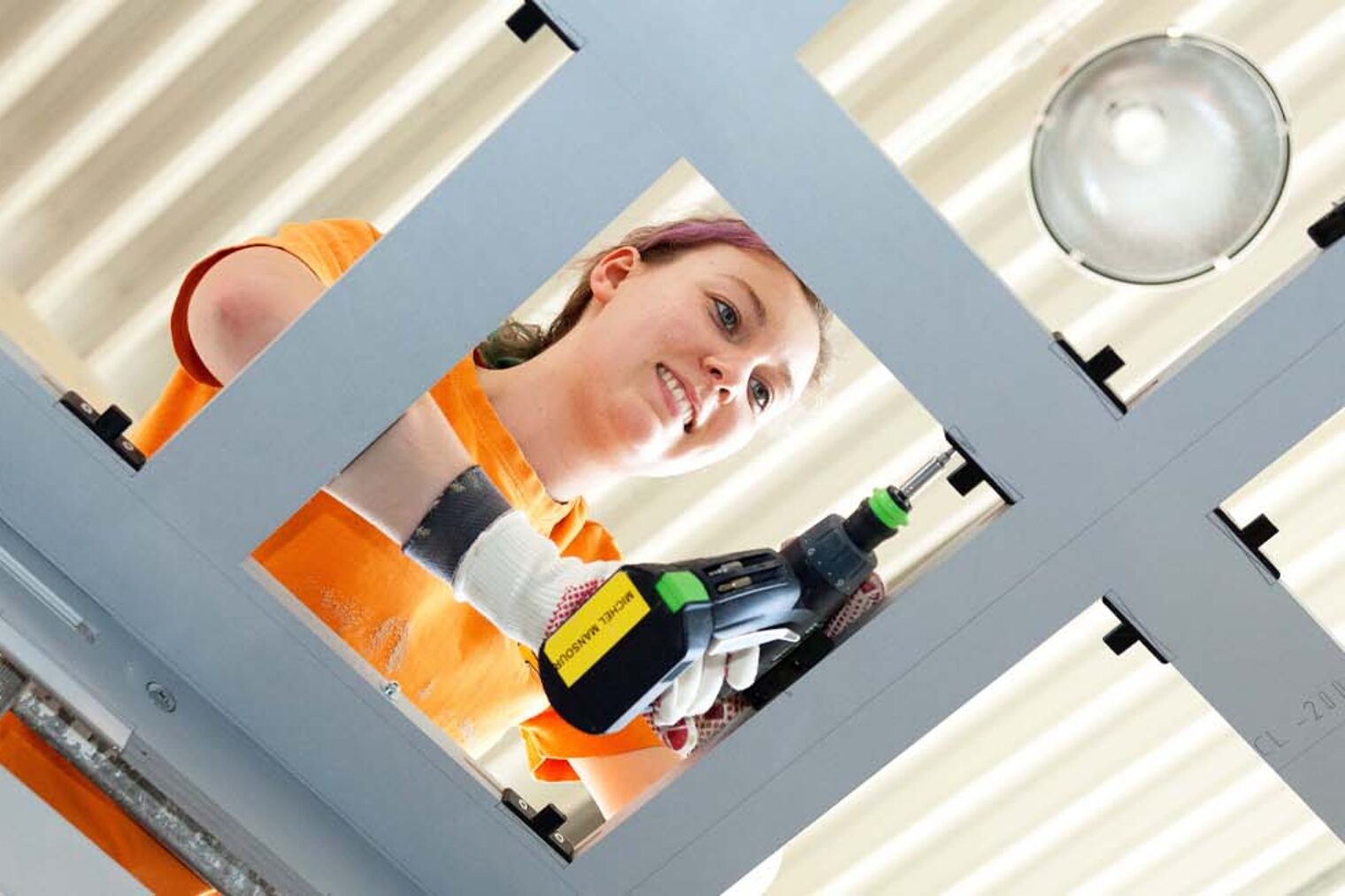 Schreinerin mit Bohrmaschine in der Hand